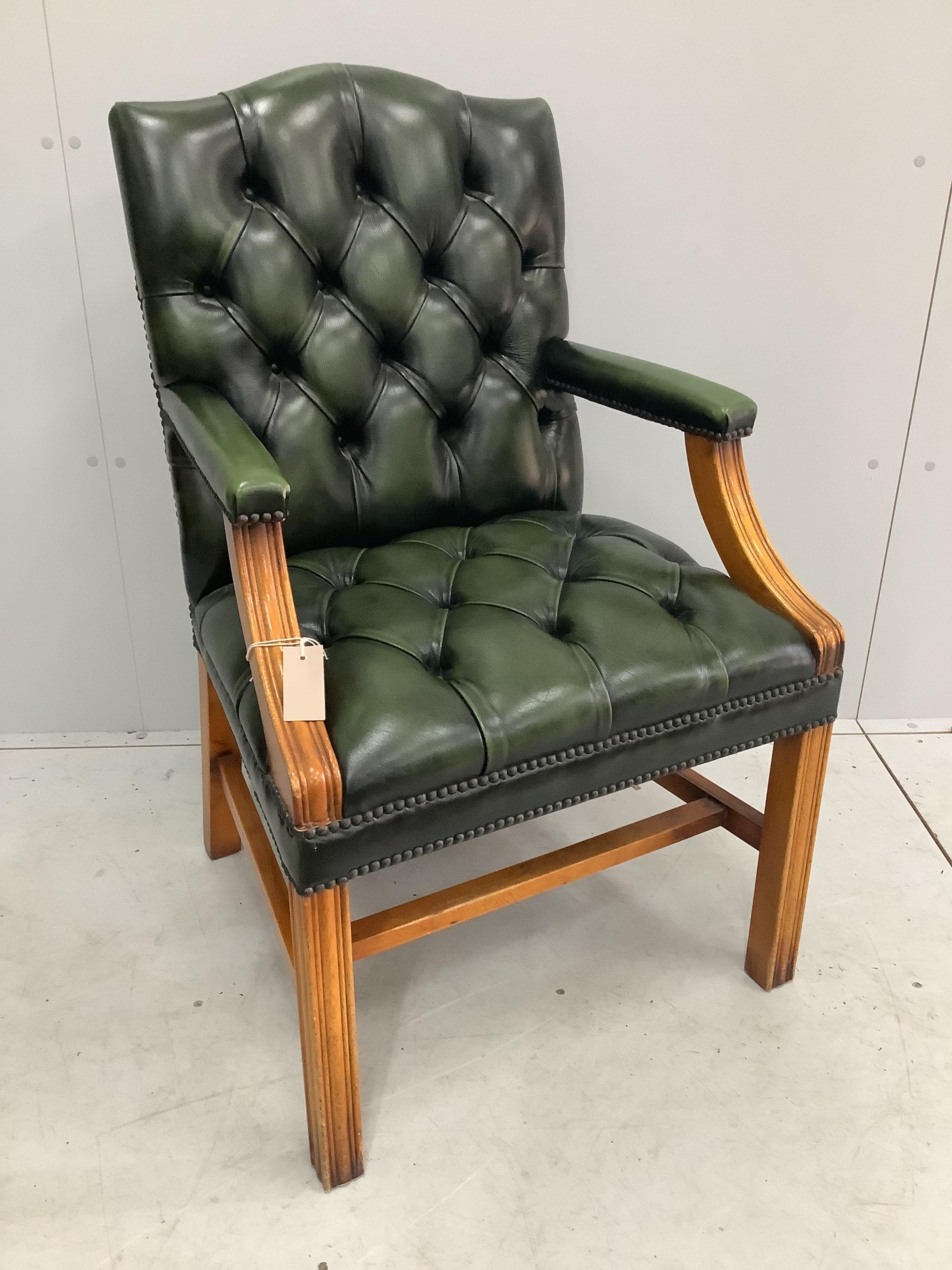 A reproduction buttoned green leather Gainsborough style desk chair, width 59cm, depth 52cm, height 101cm